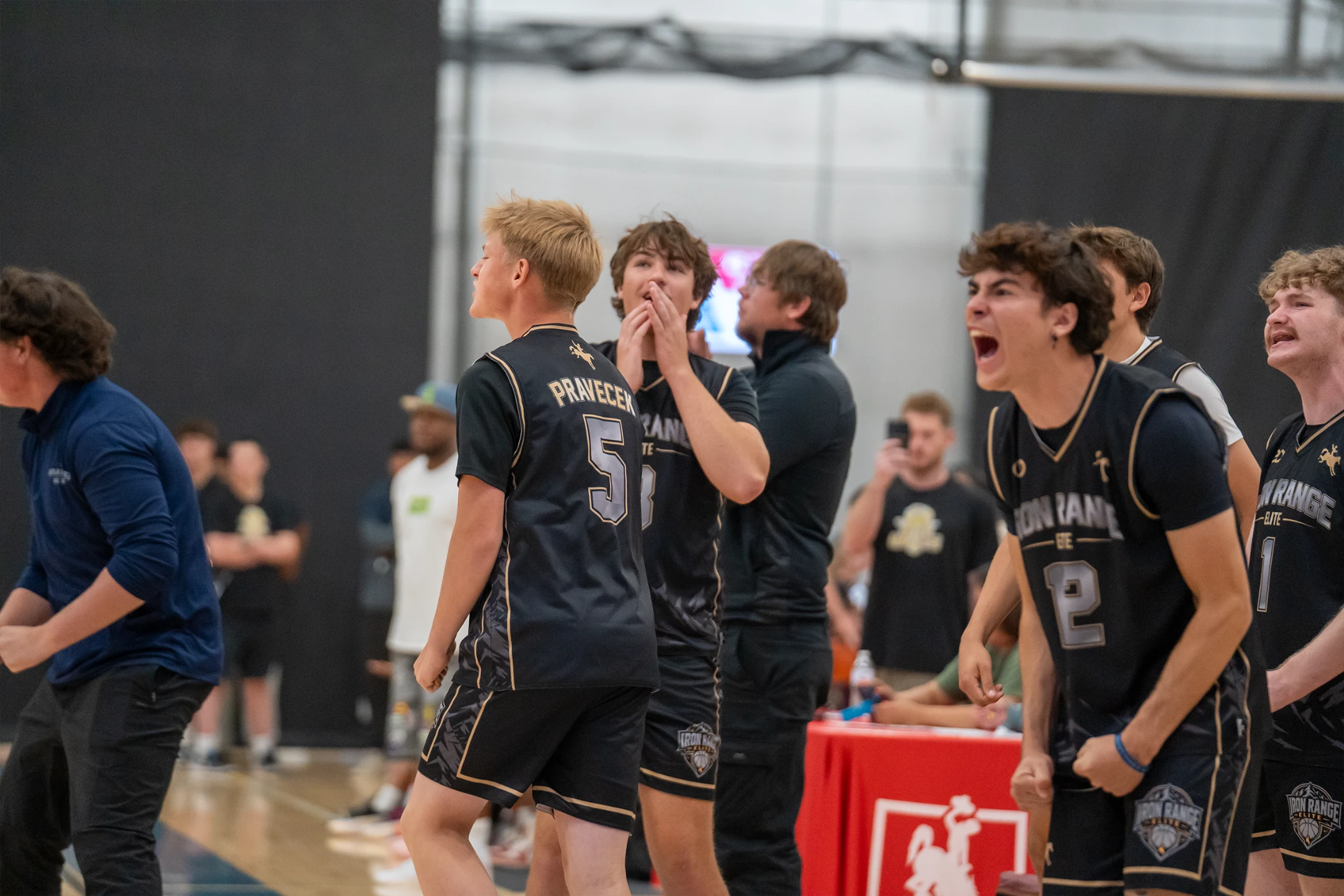 Basketball teammates cheer together on the WyoHoops Summer Showcase sideline