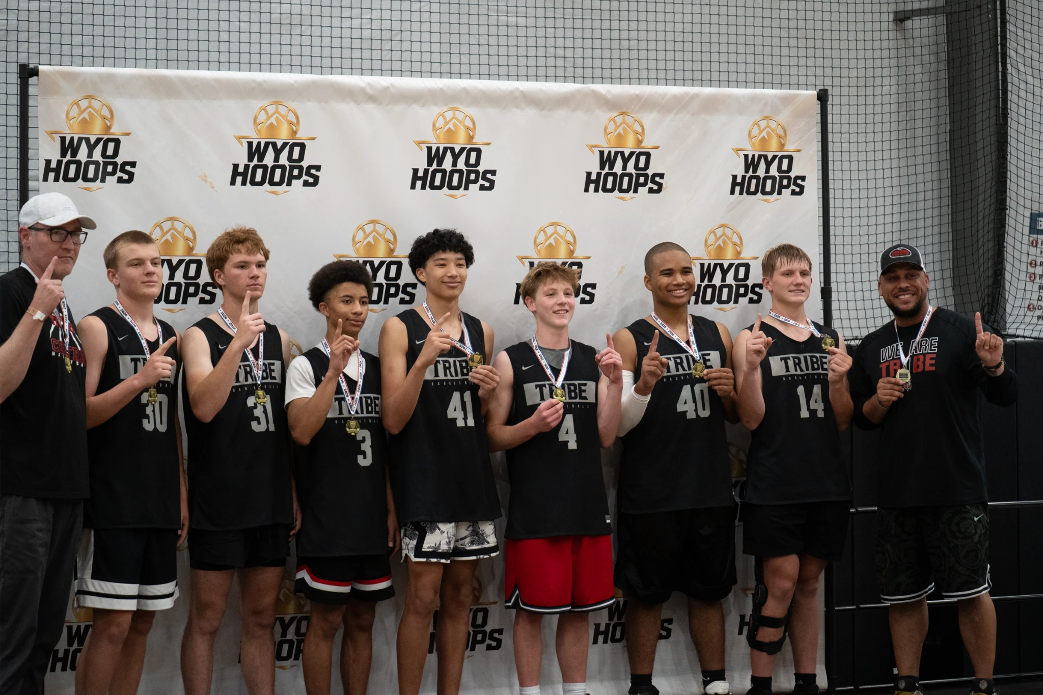 A youth basketball team celebrates with its trophy at a WyoHoops event