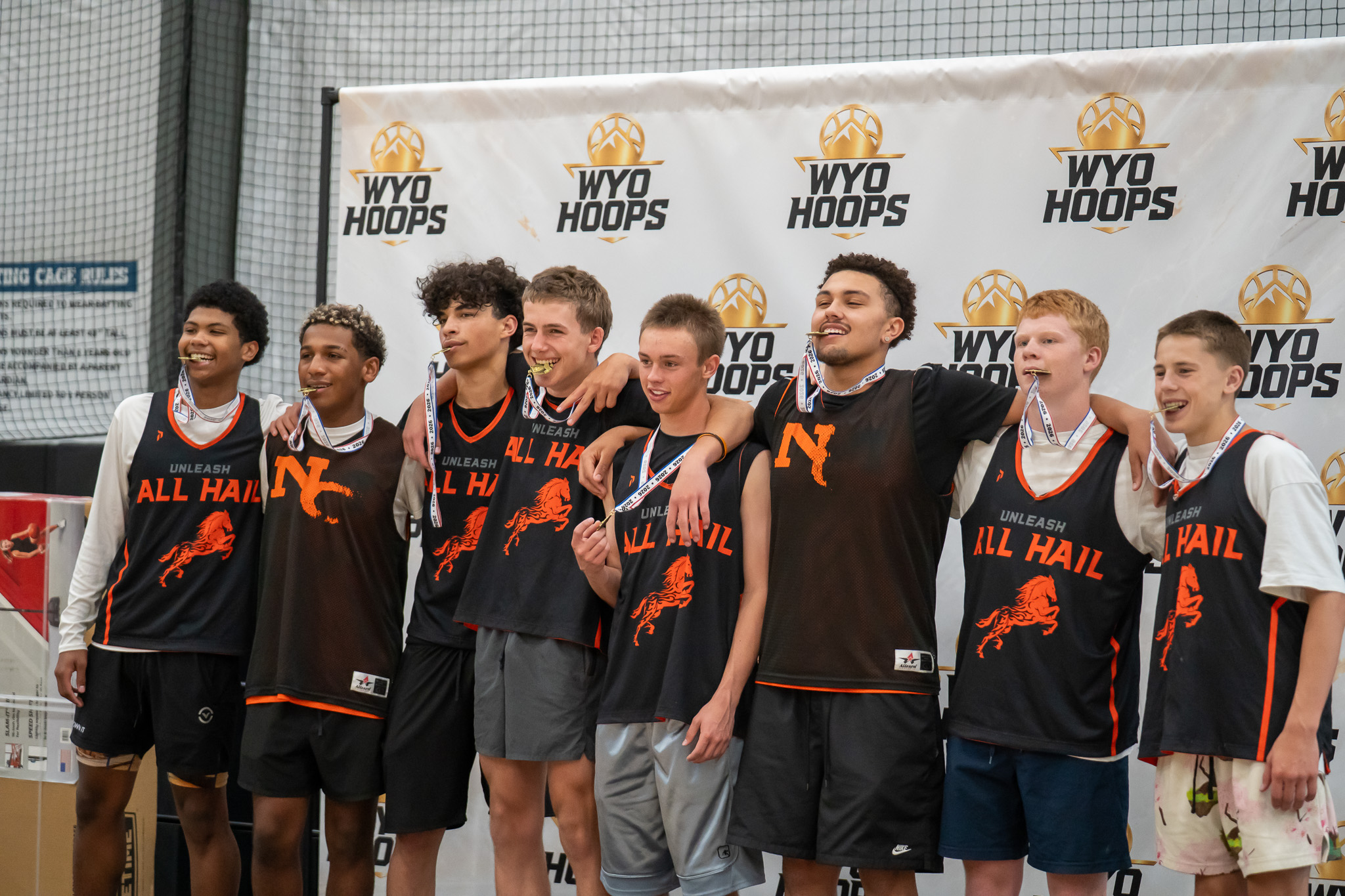 Basketball players wearing medals at a WyoHoops event