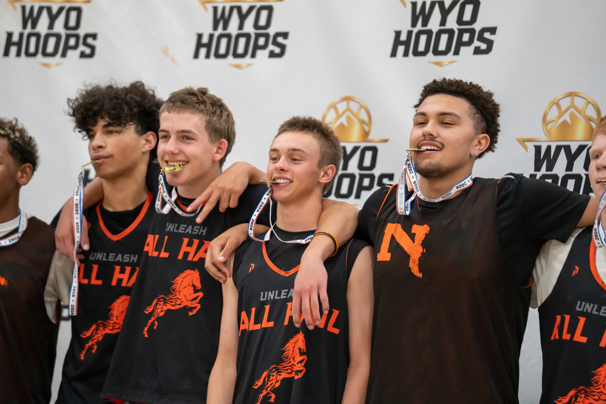 Basketball players wearing medals at a WyoHoops event