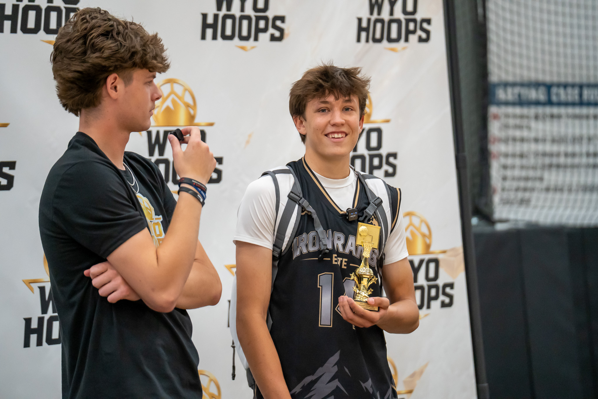 A basketball player interviewed with a trophy at a WyoHoops event