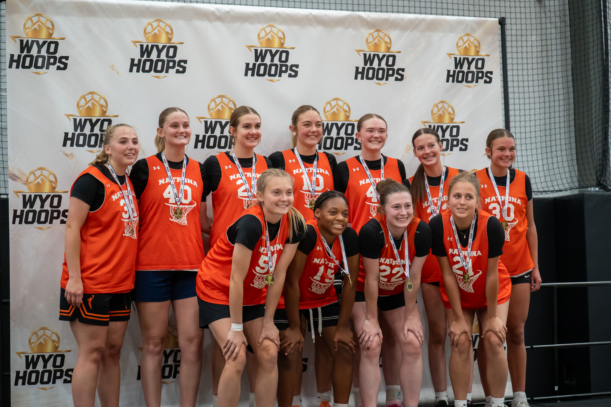 Girls basketball players wearing medals at a WyoHoops event